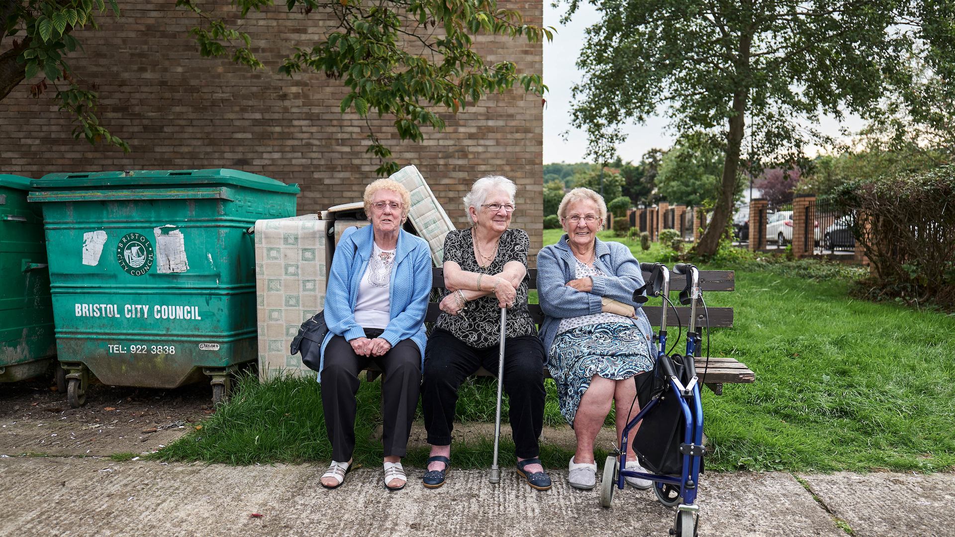 Three older women sitting on bench